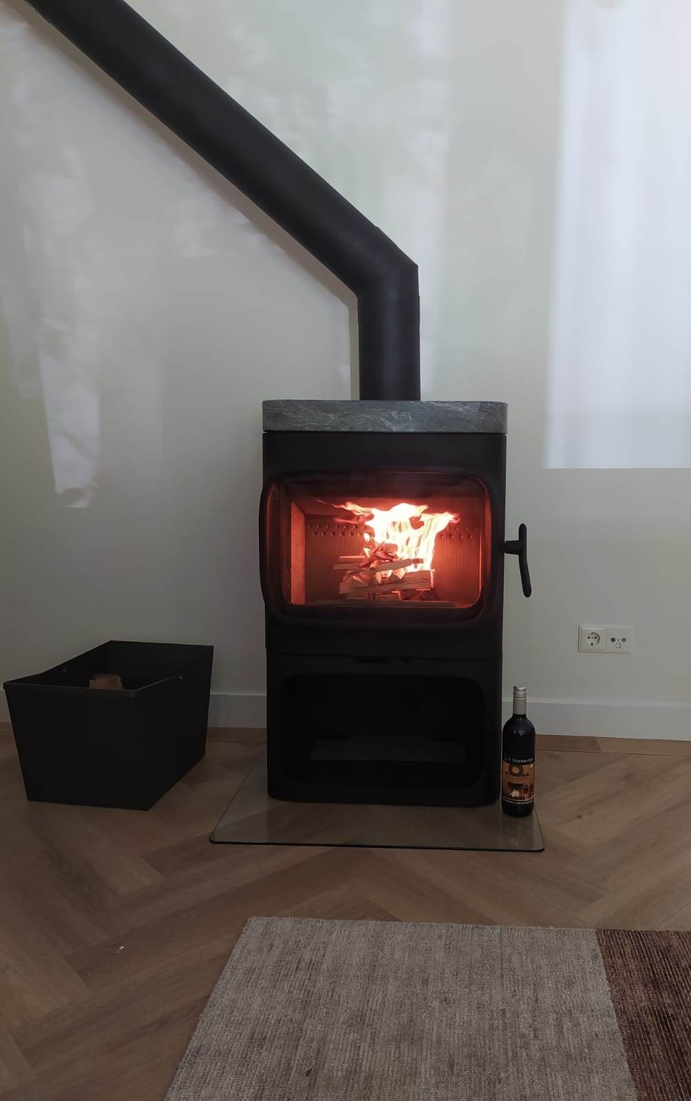 Jotul F 305 freestanding wood stove on short legs in a home with timber flooring